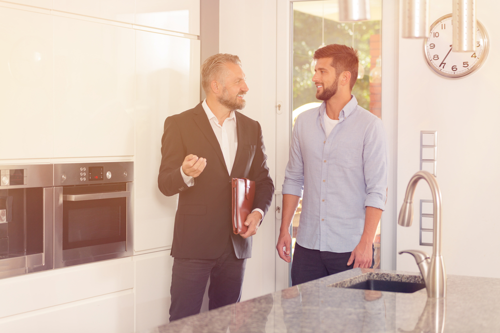 A home inspector talking to a prospective buyer