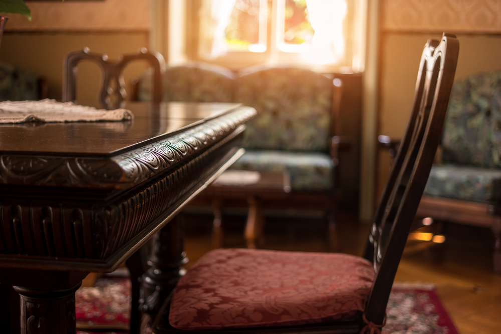 Antique table sitting in an holder home